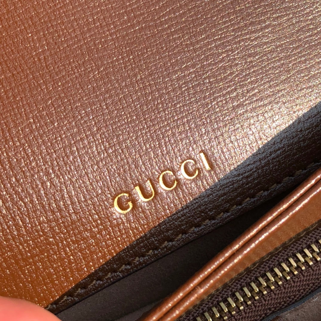 （861200898）尺寸：25×18×8cm  Gucci海外渠道资源特供1955系列马衔扣帆布单肩包❗️Gucci1955马衔扣手袋在2020早春系列中惊艳亮相，在复古当道的年代，这样一只包的岀现无疑能一眼击中人心，品牌标志性的经典元素，灵感源自马术中双环和链条的马衔扣再次出山1955的复古不仅体现在马蹄扣上，还有经典“双G”老花包身和做旧日的棕色皮革包边，所有设计运用到一起让包包充满70年代的摩登风格。同时配以可调节肩带，可在肩背和斜跨之间自由转换。