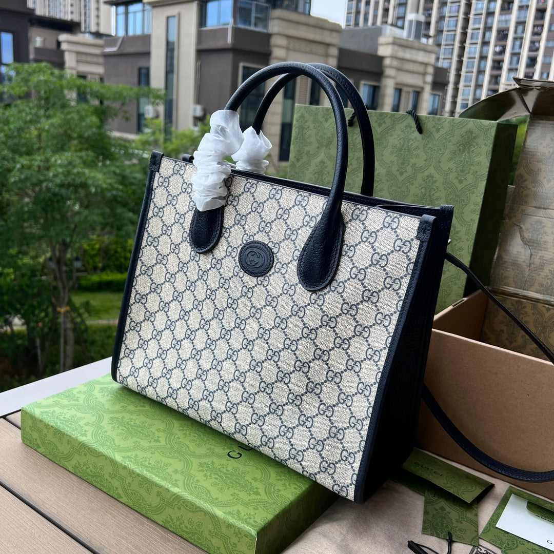 尺寸:31×26.5×14cm（071090898） Gucci海外通路資源特供托特包❗️在《古馳愛的進行曲》全新時裝系列中，品牌推出了藍色和米色的GG Supreme 帆布組合，經典雋永，傳承品牌經典材質的歷史淵源。對於環境的影響較低的帆布材質被長久地運用於多個系列當中，已成為品牌的標誌性材質。這款小號互扣式雙G托特包採用經典配色環保材質，以藍色皮革滾邊，可手提肩背，長肩帶可拆卸可調節