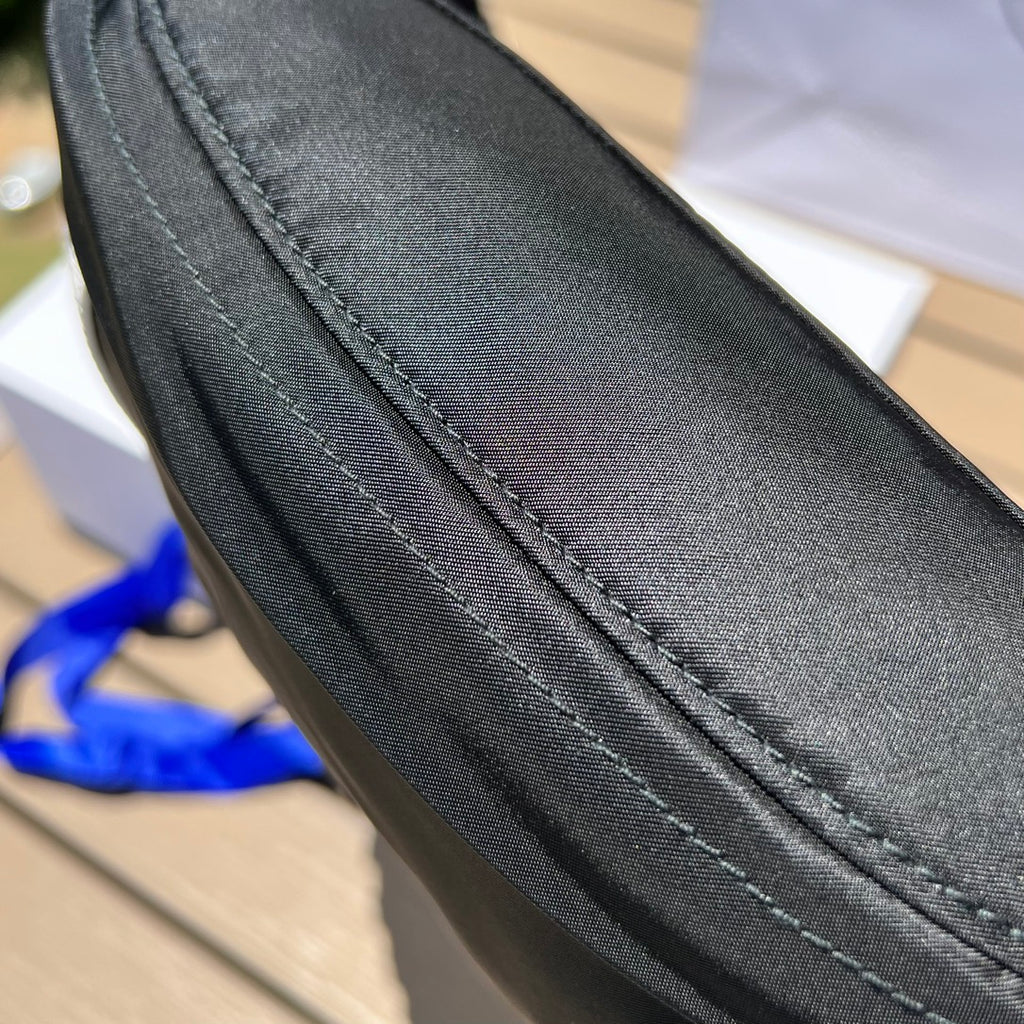 可調式尼龍腰帶和側面插扣，拉鍊開合琺瑯金屬三角形標誌與adidas Re -Nylon 徽標